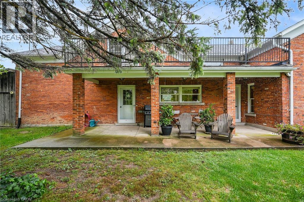 Rear view of property with a lawn, a patio, and brick siding - 2432 Seburn Road, Fonthill, ON - Outdoor