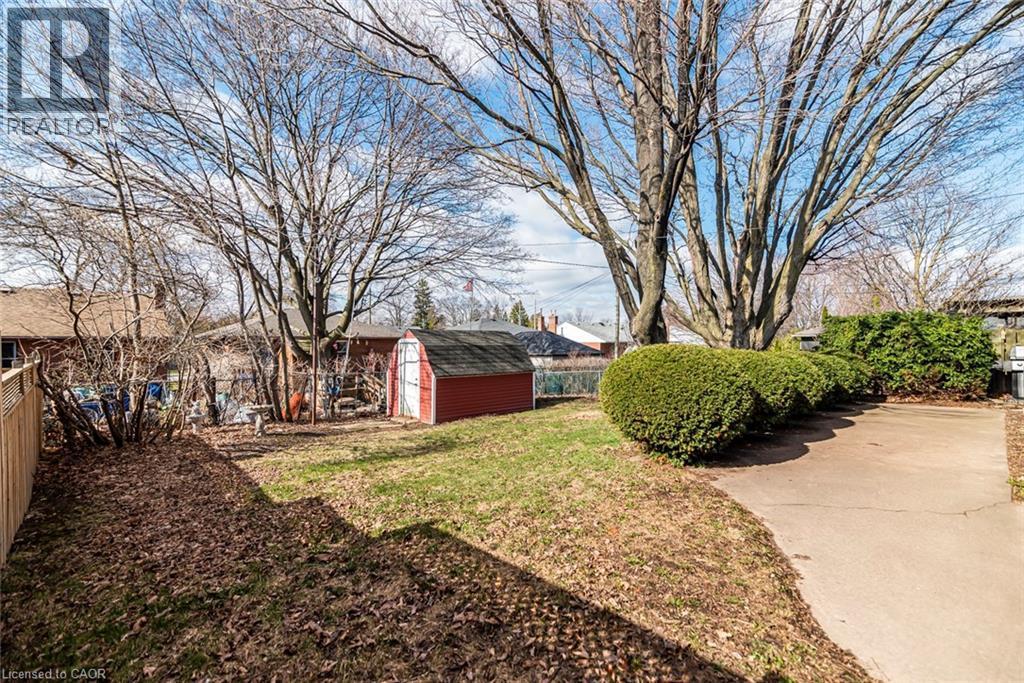 Fenced backyard featuring a storage shed - 124 Broker Drive, Hamilton, ON - Outdoor