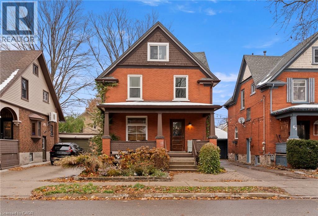 American foursquare style home featuring brick siding and a porch - 58 Hohner Avenue, Kitchener, ON - Outdoor With Deck Patio Veranda With Facade