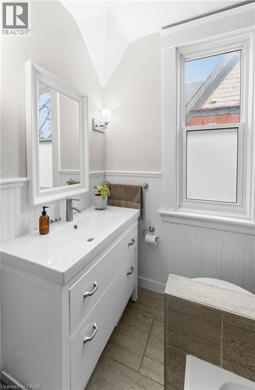Bathroom featuring wainscoting, vanity, and lofted ceiling - 58 Hohner Avenue, Kitchener, ON - Indoor Photo Showing Bathroom