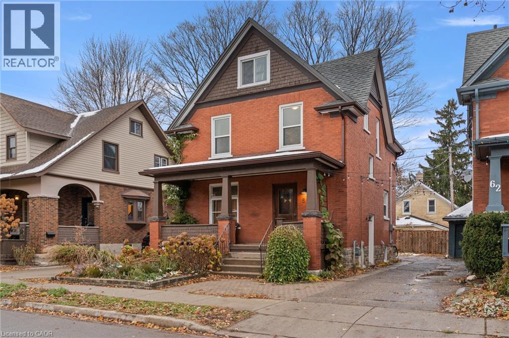 View of front of house with brick siding and covered porch - 58 Hohner Avenue, Kitchener, ON - Outdoor With Deck Patio Veranda With Facade