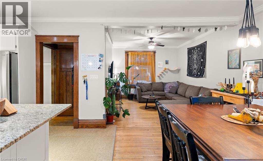 Living room featuring light wood-style floors, crown molding, and a ceiling fan - 58 Hohner Avenue, Kitchener, ON - Indoor