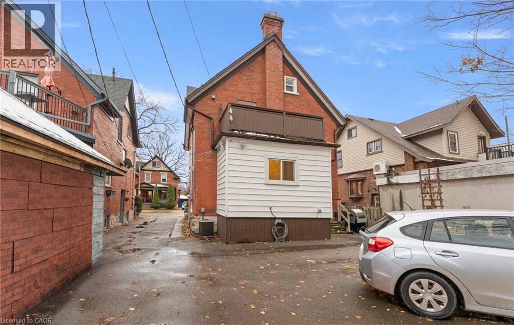 Back of house with a chimney, a balcony, and brick siding - 58 Hohner Avenue, Kitchener, ON - Outdoor