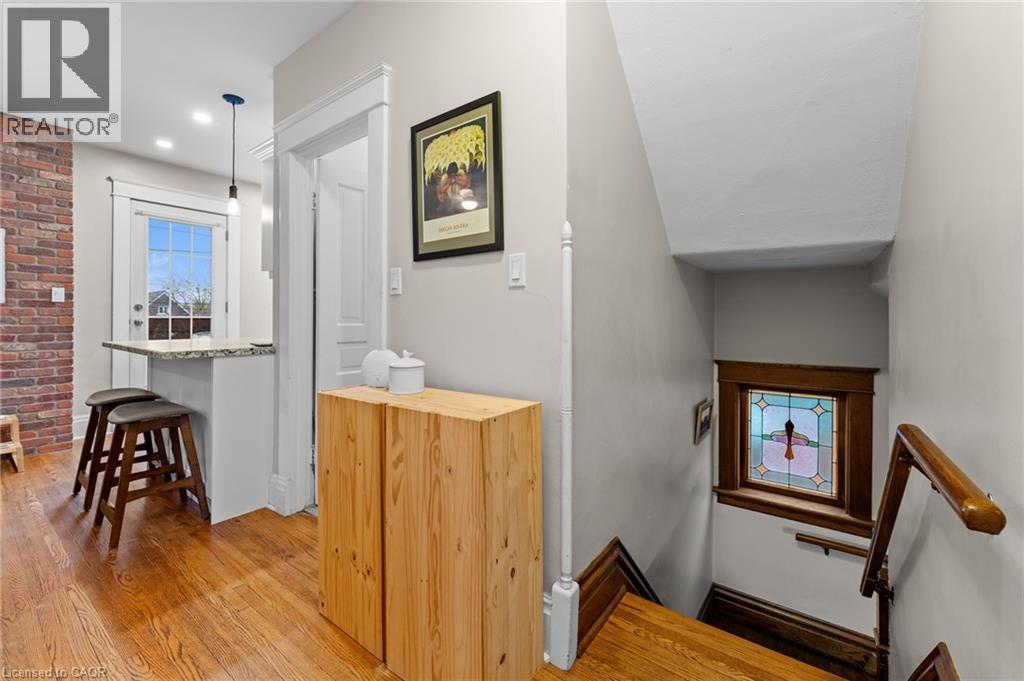 Staircase with healthy amount of natural light and hardwood / wood-style flooring - 58 Hohner Avenue, Kitchener, ON - Indoor Photo Showing Other Room