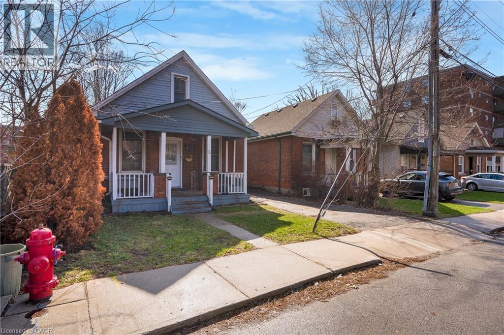 Bungalow-style house with covered porch and a front lawn - 6 Ben Lomond Place, Hamilton, ON - Outdoor With Deck Patio Veranda