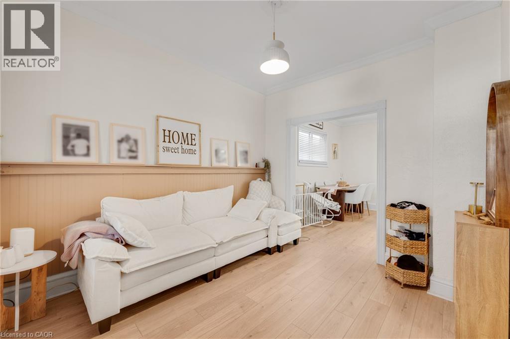 Living room with ornamental molding and light wood finished floors - 6 Ben Lomond Place, Hamilton, ON - Indoor Photo Showing Living Room