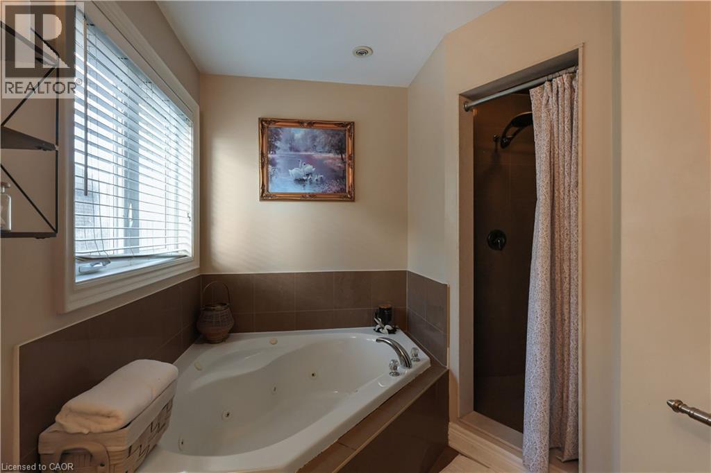 Bathroom featuring a stall shower and a whirlpool tub - 254 Rymal Road W, Hamilton, ON - Indoor Photo Showing Bathroom