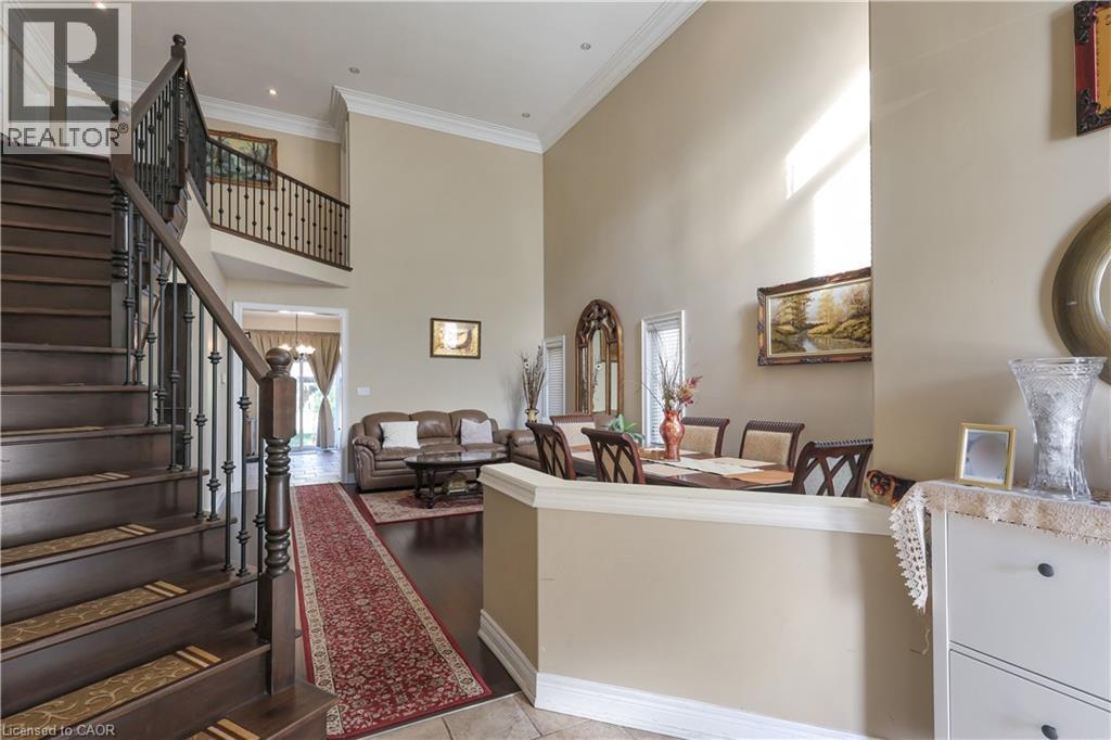 Living room with a high ceiling, healthy amount of natural light, crown molding, and light tile patterned flooring - 254 Rymal Road W, Hamilton, ON - Indoor Photo Showing Other Room