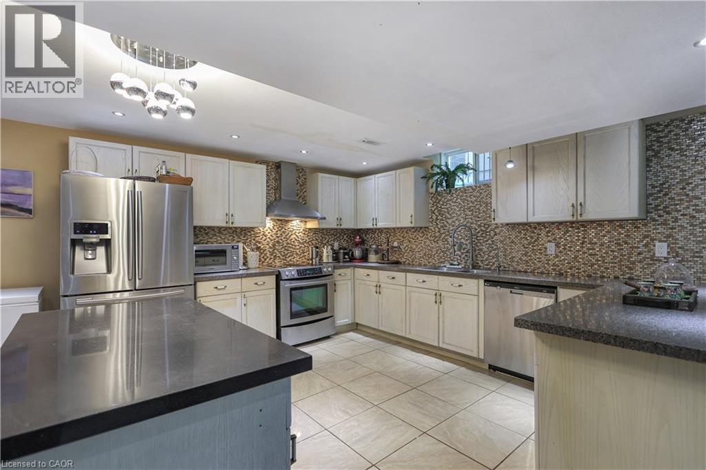Kitchen with stainless steel appliances, light tile patterned floors, recessed lighting, and dark stone countertops - 254 Rymal Road W, Hamilton, ON - Indoor Photo Showing Kitchen With Upgraded Kitchen