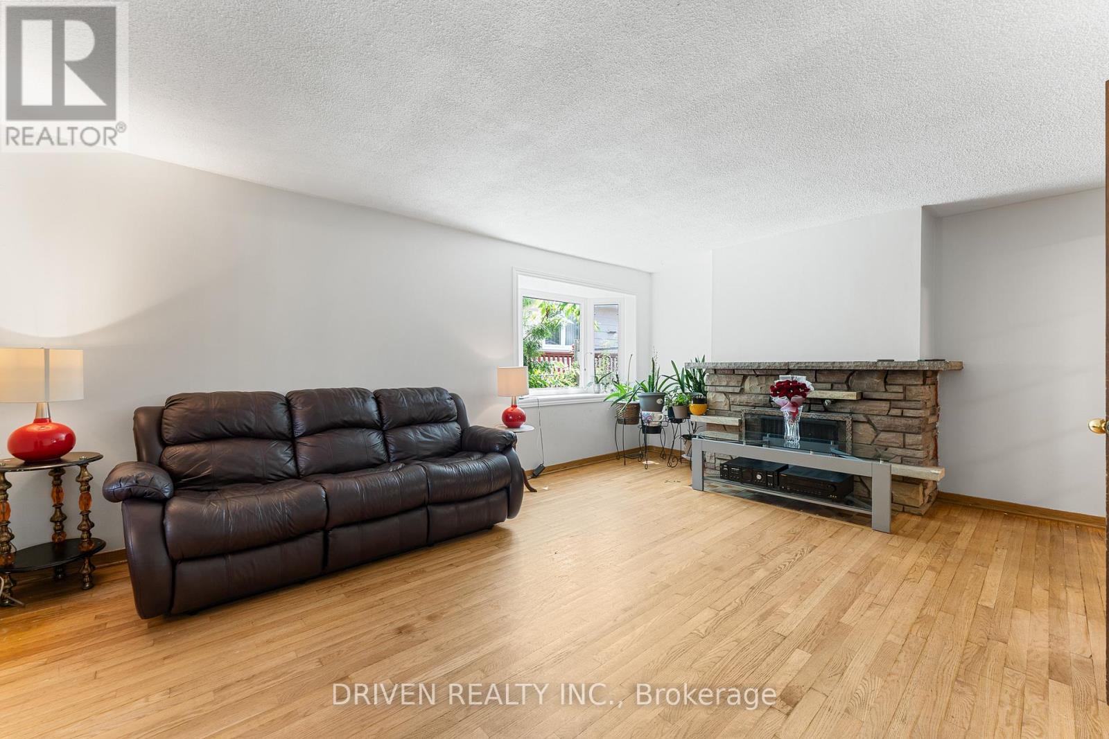 Bright living spaces with fireplace charm. - 876 Pinecrest Road, Ottawa, ON - Indoor Photo Showing Living Room