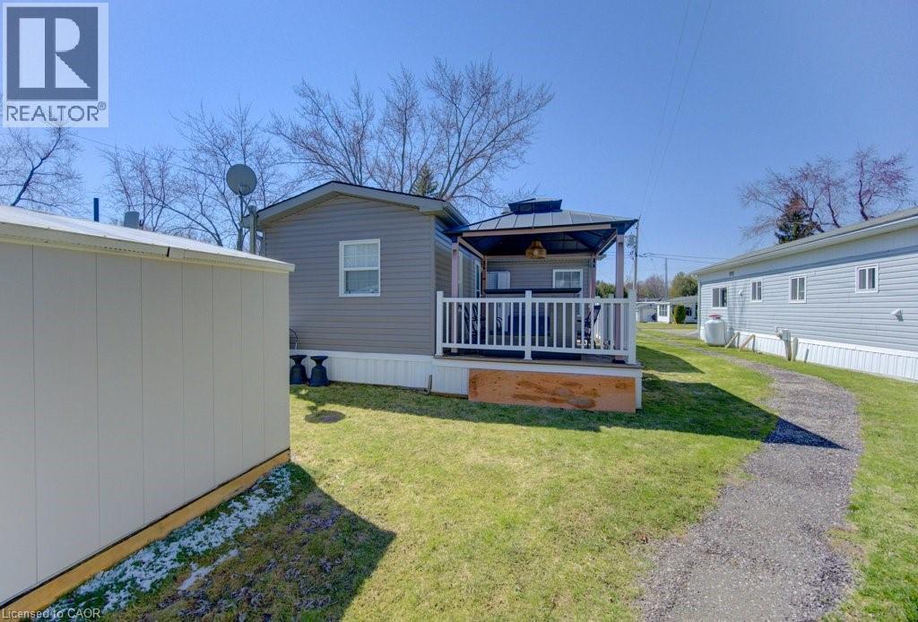 Back of property featuring a lawn, a gazebo, and a shed - 580 Beaver Creek Road Unit# 185, Waterloo, ON - Outdoor