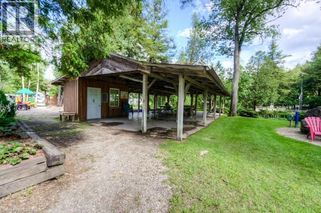 View of property's community featuring a patio and view of wooded area - 580 Beaver Creek Road Unit# 185, Waterloo, ON - Outdoor