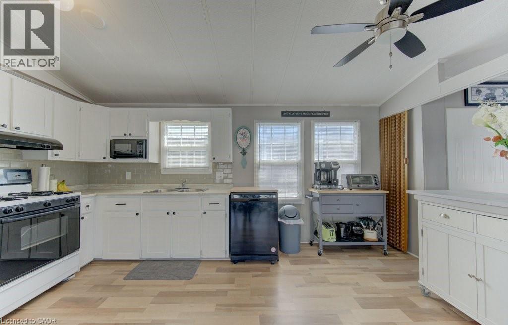 Kitchen featuring black appliances, white cabinets, light countertops, lofted ceiling, and a ceiling fan - 580 Beaver Creek Road Unit# 185, Waterloo, ON - Indoor Photo Showing Kitchen