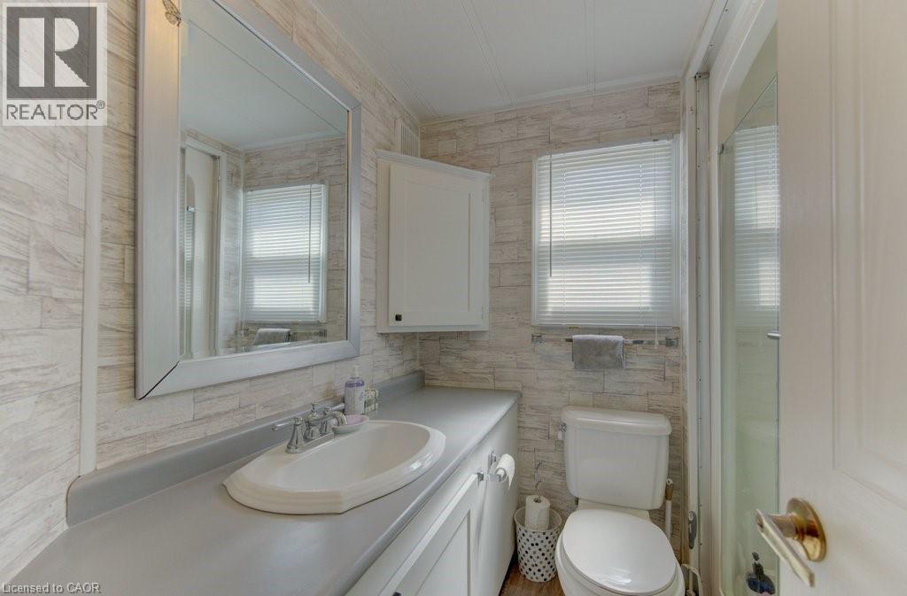 Bathroom with vanity, an enclosed shower, and tile walls - 580 Beaver Creek Road Unit# 185, Waterloo, ON - Indoor Photo Showing Bathroom
