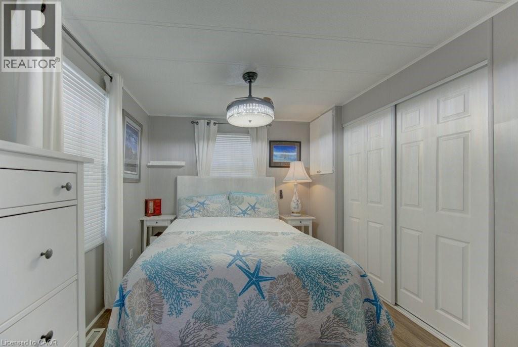 Bedroom with a closet and wood finished floors - 580 Beaver Creek Road Unit# 185, Waterloo, ON - Indoor Photo Showing Bedroom