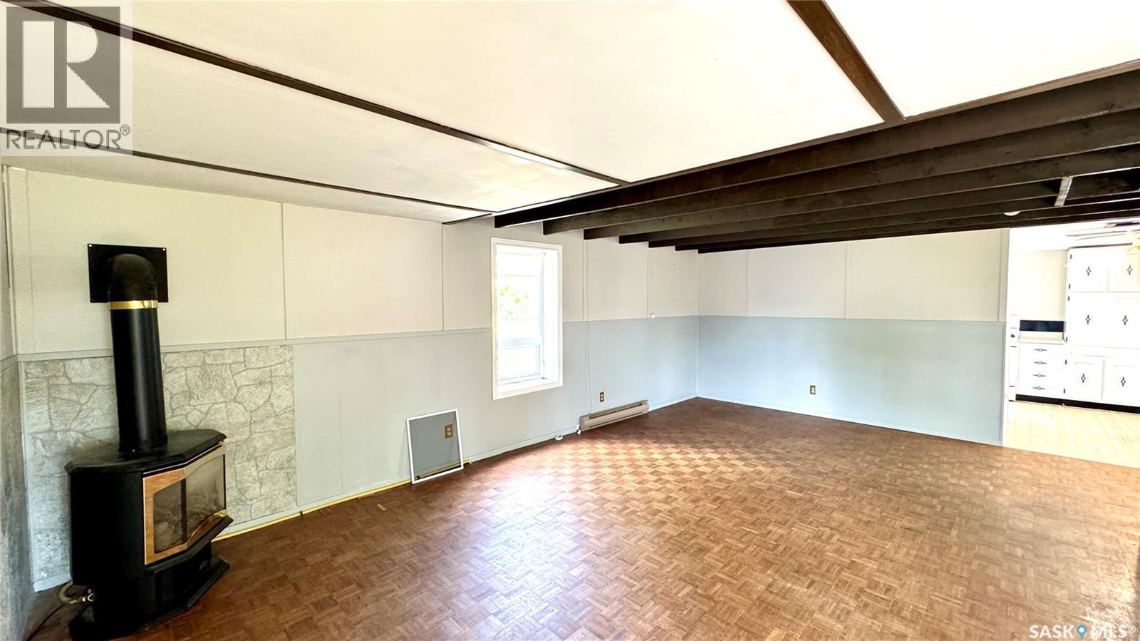 209 1St Street E, Dinsmore, SK - Indoor Photo Showing Other Room With Fireplace