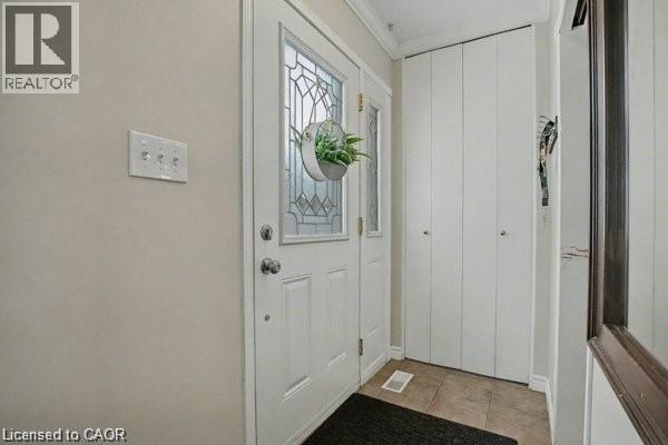 Doorway to outside featuring ornamental molding and tile patterned flooring - 11 Carwyn Crescent, Hamilton, ON - Indoor Photo Showing Other Room