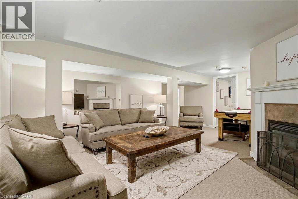 Living area featuring a premium fireplace and carpet floors - 11 Carwyn Crescent, Hamilton, ON - Indoor Photo Showing Living Room With Fireplace