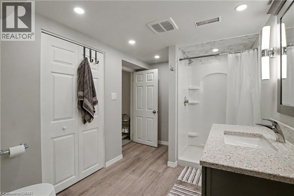 Bathroom with a stall shower, vanity, light wood-style floors, recessed lighting, and a closet - 11 Carwyn Crescent, Hamilton, ON - Indoor Photo Showing Bathroom