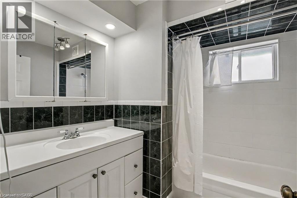 Bathroom with vanity, tile walls, and shower / bath combination with curtain - 11 Carwyn Crescent, Hamilton, ON - Indoor Photo Showing Bathroom