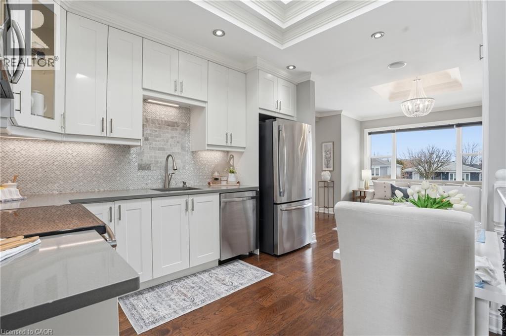 Bedtime is nothing but dreams in this primary bedroom; featuring hardwood floors, large windows for njatural light & large closet. - 208 East 44Th Street, Hamilton, ON - Indoor Photo Showing Kitchen With Upgraded Kitchen