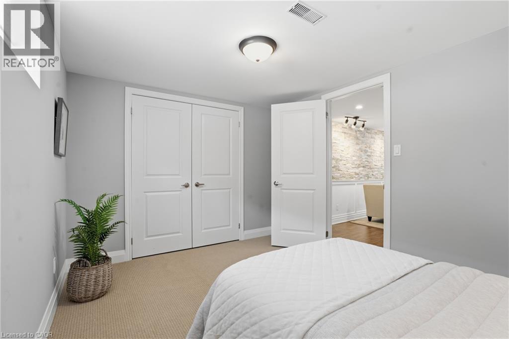 Lower level bedroom with subfloor, keeps you warm & cozy with neutral carpet and a huge walk-in closet. - 208 East 44Th Street, Hamilton, ON - Indoor Photo Showing Bedroom