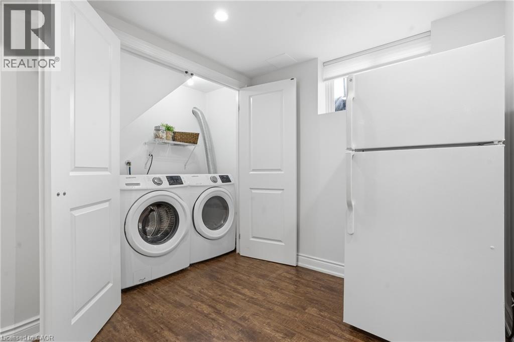 Laundry closet is discreetly located behind double doors in the lower level. Side by side, FULL SIZE washer and dryer INCLUDED! - 208 East 44Th Street, Hamilton, ON - Indoor Photo Showing Laundry Room