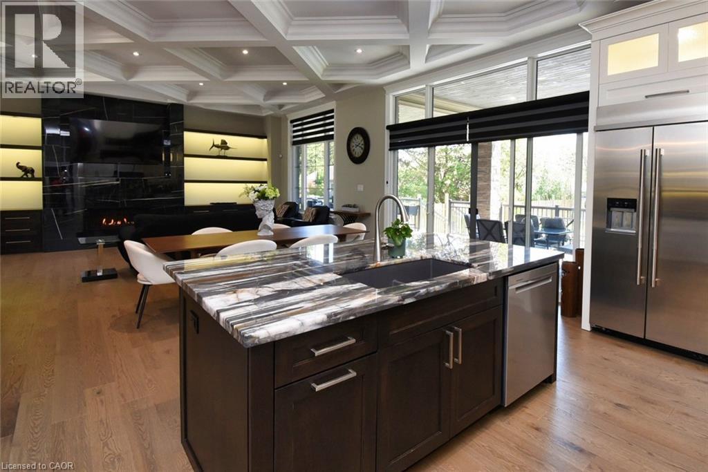 Kitchen with coffered ceiling, stainless steel appliances, open floor plan, dark wood finish cabinetry, and light wood-style floors - 68 Mountain Brow Boulevard, Hamilton, ON - Indoor Photo Showing Kitchen With Upgraded Kitchen