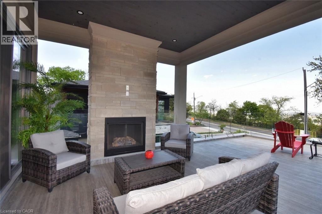 View of patio / terrace with an outdoor living space with a fireplace and a deck - 68 Mountain Brow Boulevard, Hamilton, ON - Photo Showing Living Room With Fireplace