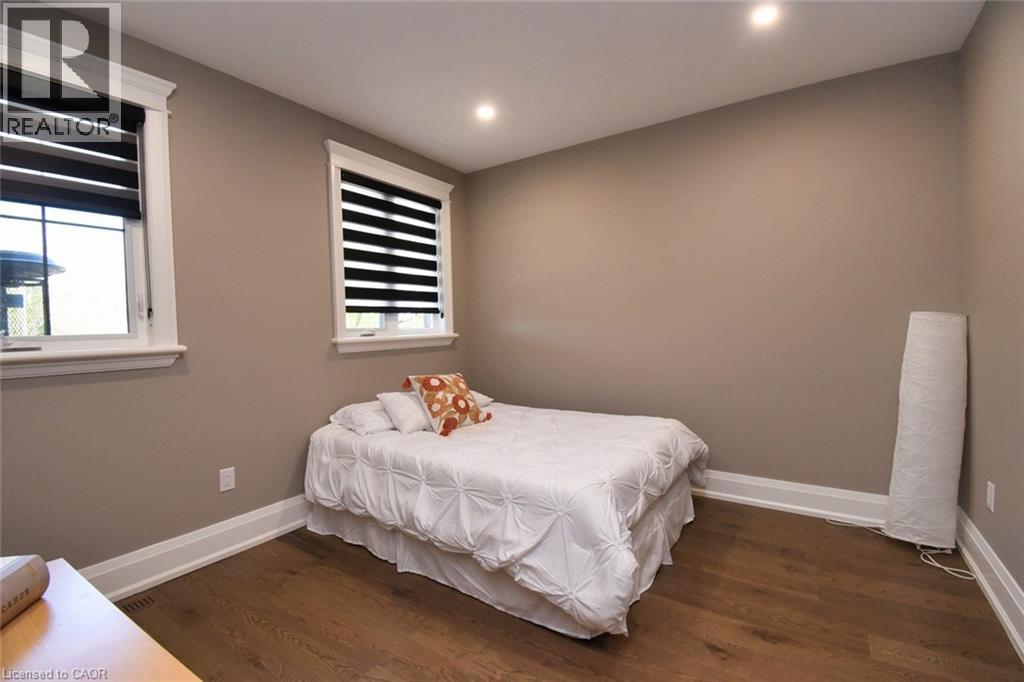 Bedroom featuring dark wood-style flooring, multiple windows, and recessed lighting - 68 Mountain Brow Boulevard, Hamilton, ON - Indoor Photo Showing Bedroom