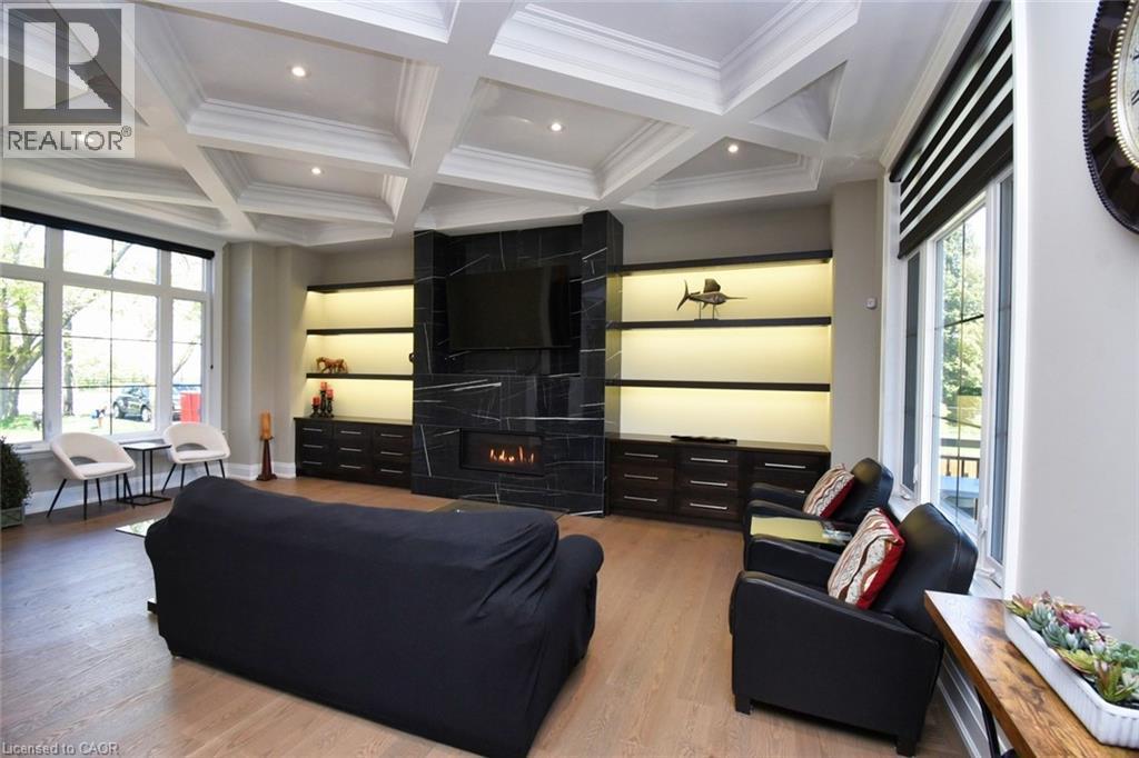 Living area featuring coffered ceiling, wood finished floors, a large fireplace, recessed lighting, and ornamental molding - 68 Mountain Brow Boulevard, Hamilton, ON - Indoor