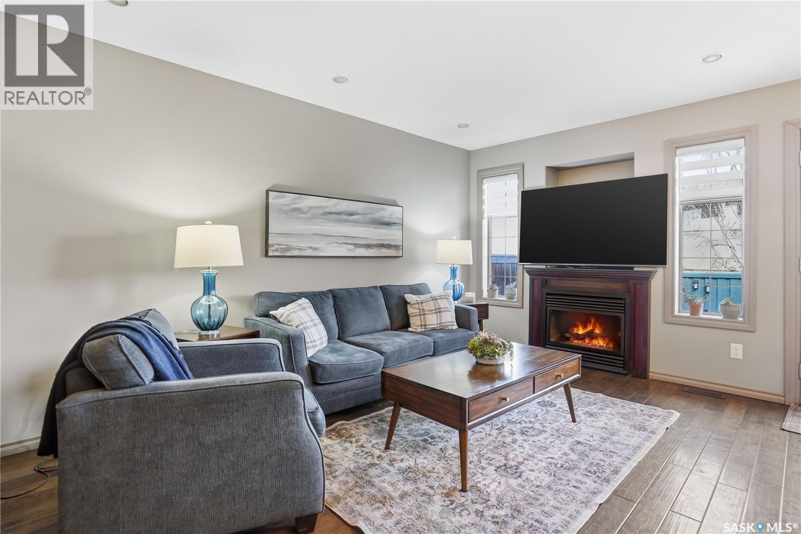 111 2501 Windsor Park Road, Regina, SK - Indoor Photo Showing Living Room With Fireplace