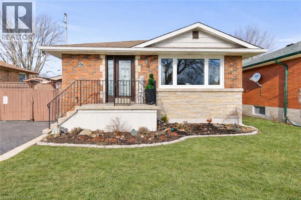 View of front facade featuring stone siding and a front lawn - 96 Terrace Drive, Hamilton, ON - Outdoor