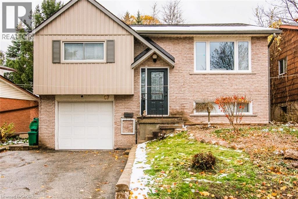 Split foyer home with a garage, brick siding, and driveway - 67 Pinemeadow Crescent, Waterloo, ON - Outdoor With Exterior