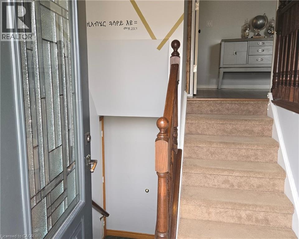 Stairway with baseboards and wood finished floors - 67 Pinemeadow Crescent, Waterloo, ON - Indoor Photo Showing Other Room