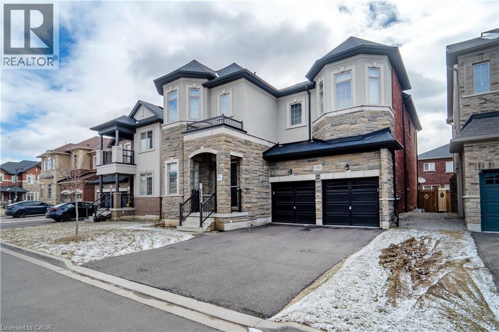 View of front facade with stone siding, stucco siding, asphalt driveway, and an attached garage - 150 Goodwin Crescent Unit# Bsmt, Milton, ON - Outdoor With Facade