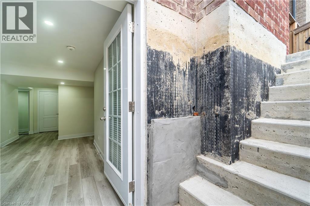 Stairs featuring wood finished floors and recessed lighting - 150 Goodwin Crescent Unit# Bsmt, Milton, ON - Photo Showing Other Room