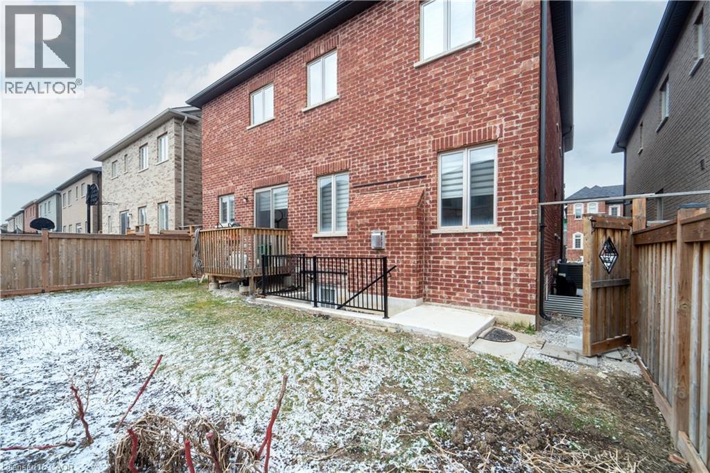 Back of property featuring brick siding and a fenced backyard - 150 Goodwin Crescent Unit# Bsmt, Milton, ON - Outdoor With Exterior