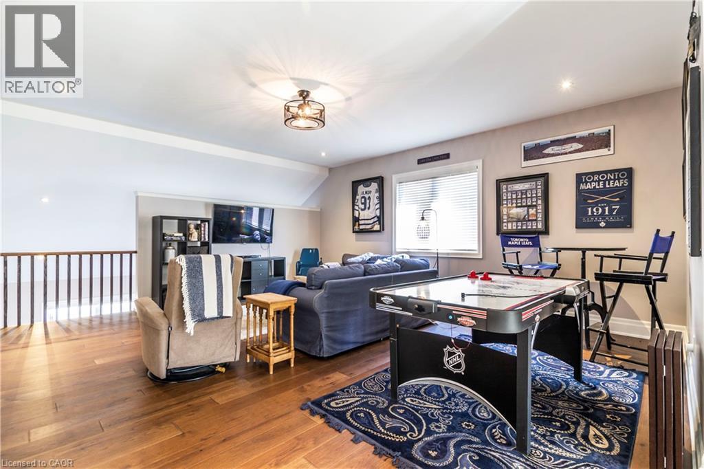 Rec room featuring wood-type flooring and vaulted ceiling - 72 Pond View Gate, Waterdown, ON - Indoor