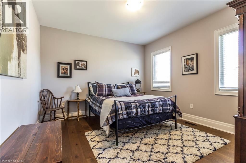 Bedroom featuring dark wood-style flooring and baseboards - 72 Pond View Gate, Waterdown, ON - Indoor Photo Showing Bedroom