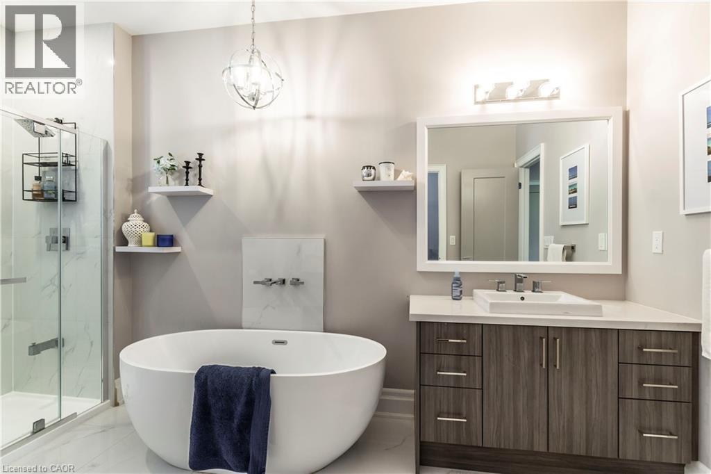 Full bathroom featuring vanity, a soaking tub, a marble finish shower, and suspended lighting - 72 Pond View Gate, Waterdown, ON - Indoor Photo Showing Bathroom