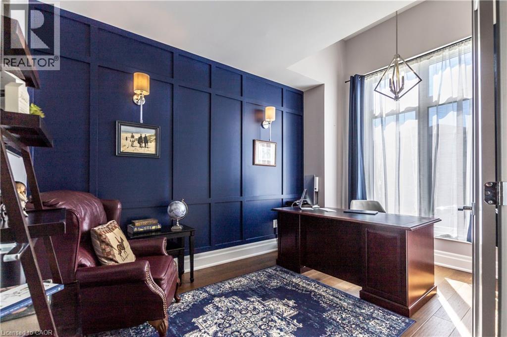 Office space with a decorative wall and dark wood-style flooring - 72 Pond View Gate, Waterdown, ON - Indoor