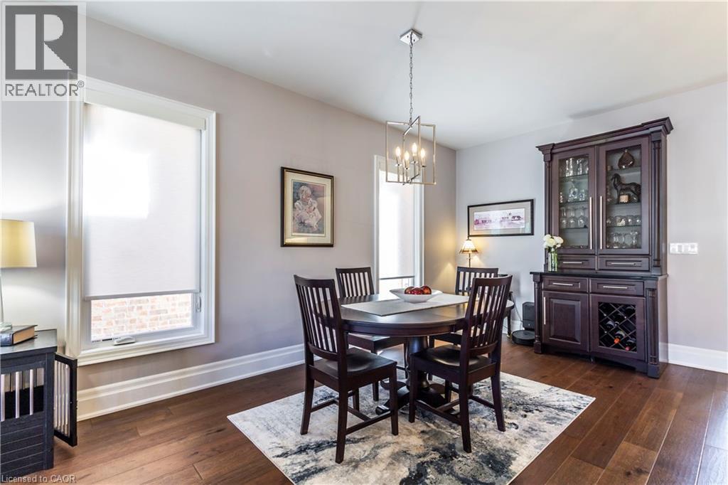Dining room with dark wood-style floors and hanging lights - 72 Pond View Gate, Waterdown, ON - Indoor Photo Showing Dining Room