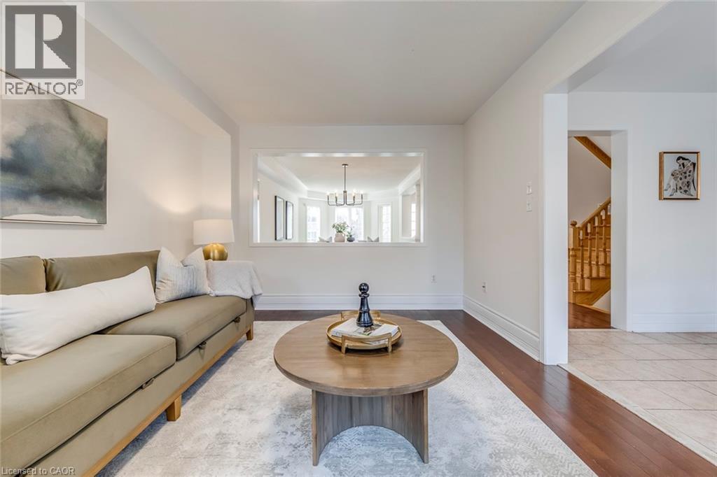 Living room with hardwood / wood-style flooring and suspended lighting - 5811 Page Crescent, Burlington, ON - Indoor Photo Showing Living Room