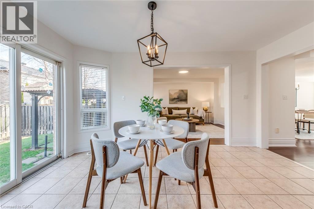 Dining space with suspended lighting and light tile patterned floors - 5811 Page Crescent, Burlington, ON - Indoor Photo Showing Dining Room