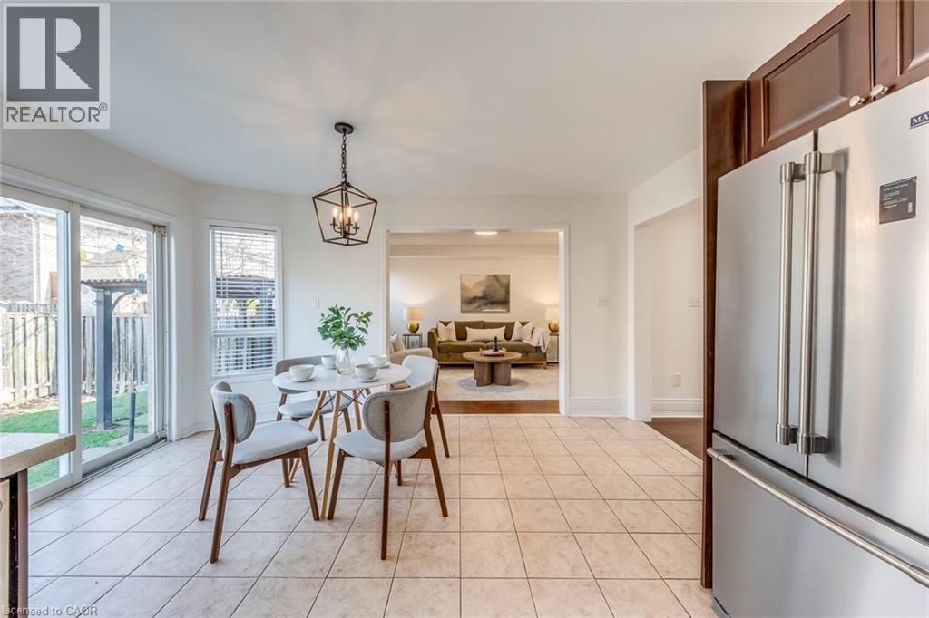 Dining room featuring a chandelier and light tile patterned floors - 5811 Page Crescent, Burlington, ON - Indoor Photo Showing Dining Room