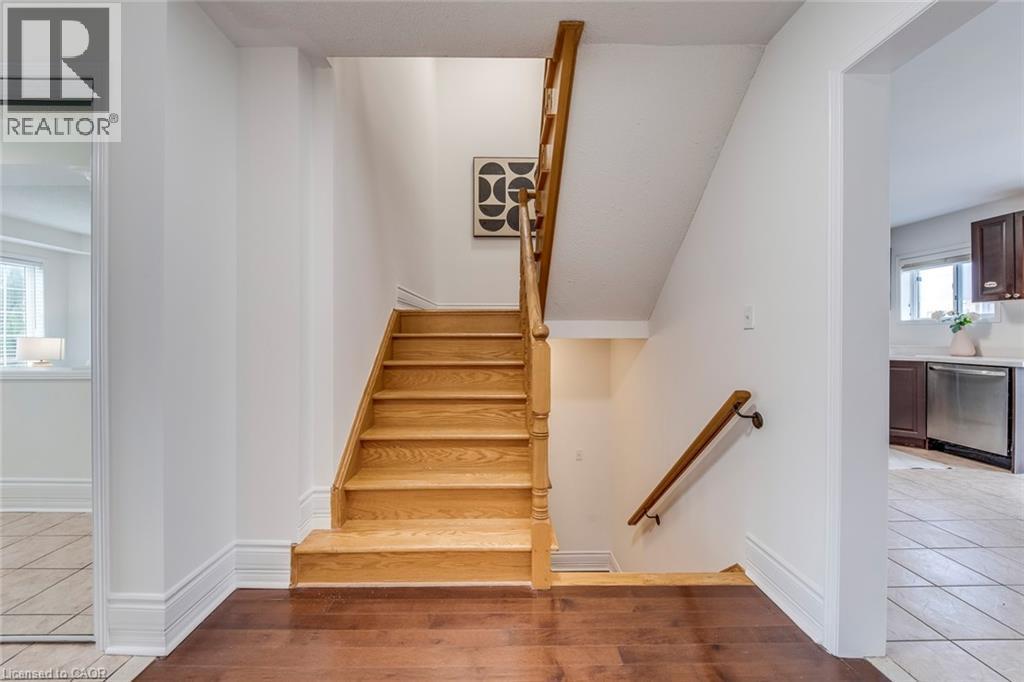 Stairs featuring wood finished floors and baseboards - 5811 Page Crescent, Burlington, ON - Indoor Photo Showing Other Room