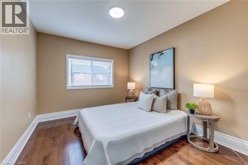 Bedroom with dark wood-style flooring and baseboards - 5811 Page Crescent, Burlington, ON - Indoor Photo Showing Bedroom
