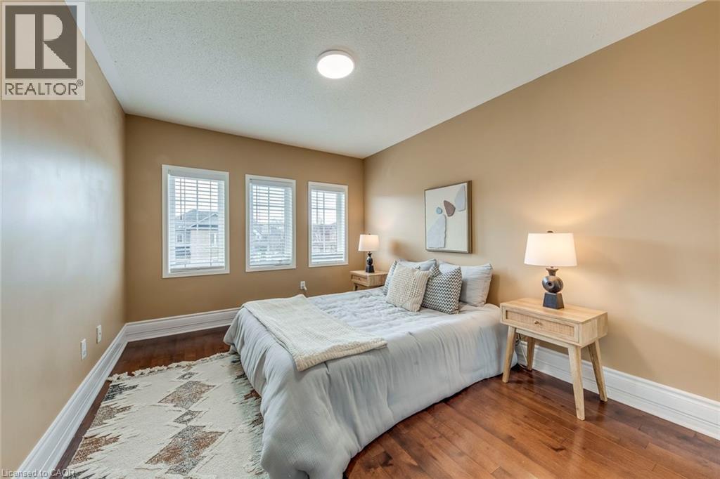 Bedroom featuring wood finished floors and a textured ceiling - 5811 Page Crescent, Burlington, ON - Indoor Photo Showing Bedroom