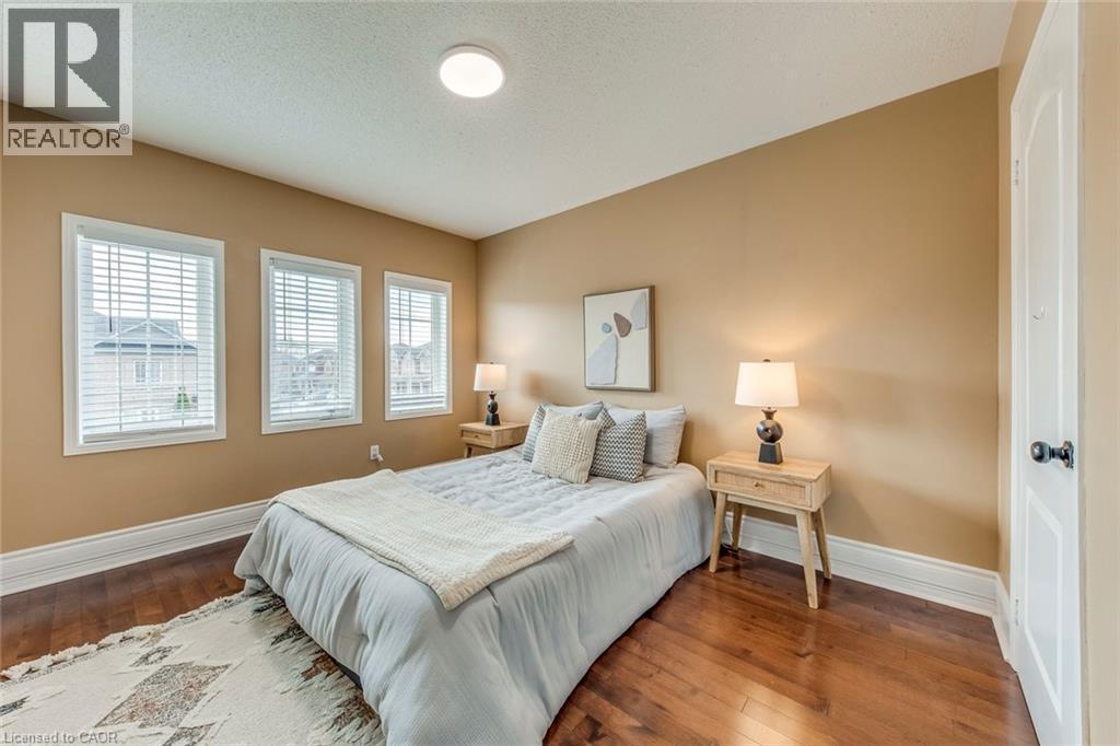 Bedroom featuring hardwood / wood-style flooring and a textured ceiling - 5811 Page Crescent, Burlington, ON - Indoor Photo Showing Bedroom